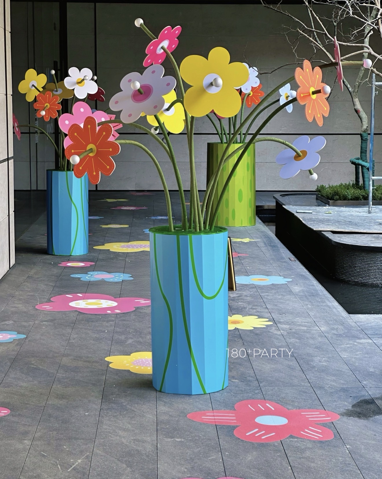 Oversized colorful flower sculptures with floral floor decals